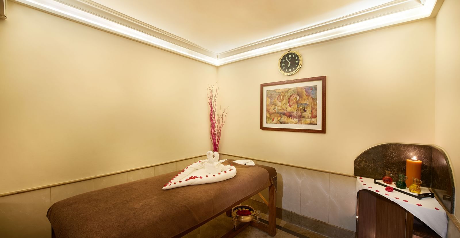 An image of a room with a massage bed and a cabinet tool where spa products are kept at Accord Hotels and Resorts, one of the best 5 star luxury spa hotels in Chennai.
